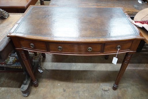 A Regency style mahogany bow front three drawer writing table, width 101cm, depth 61cm, height 76cm